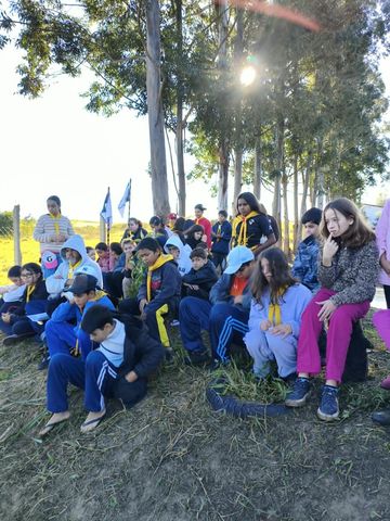 Participantes reunidos ao ar livre durante a atividade de instrução de fogueiras.